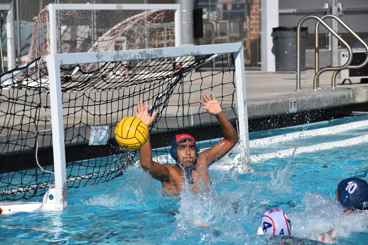 Gurshaan (#1), Norths water polo goalie, blocking a shot from #4 on the opposing team. 