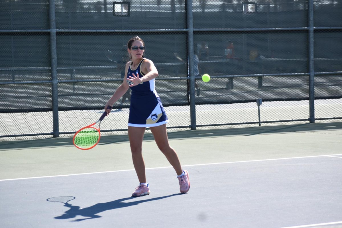 Caroline returning the ball with a forehand shot.
