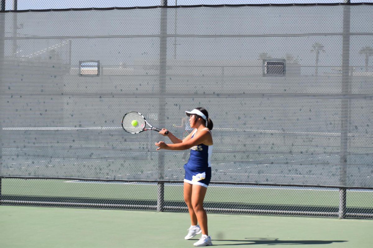 Ellen returning the ball with a forehand shot.