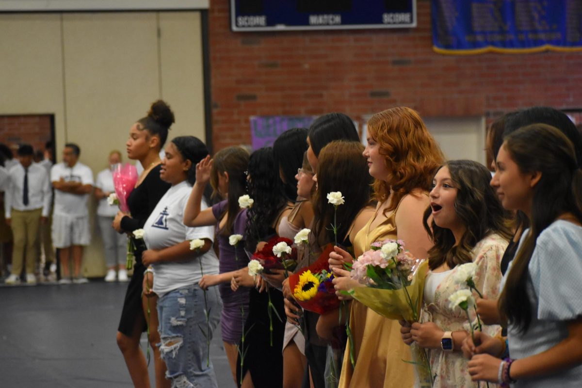 Freshmen Sweethearts waiting to give the Senior Queens their flowers.