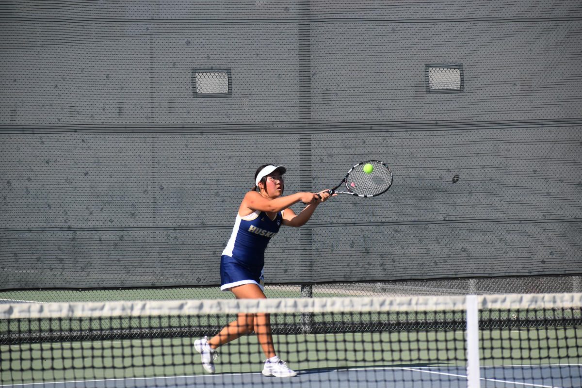 Ellen Myung, singles 3, returning the ball with a backhand.