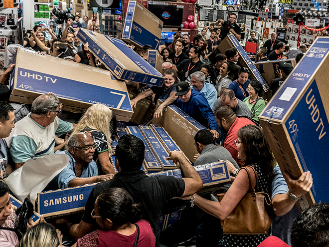 Shoppers fight over TVs at an electronics retailer on Black Friday in 2018 (Cris Faga/NurPhoto via Getty Images)