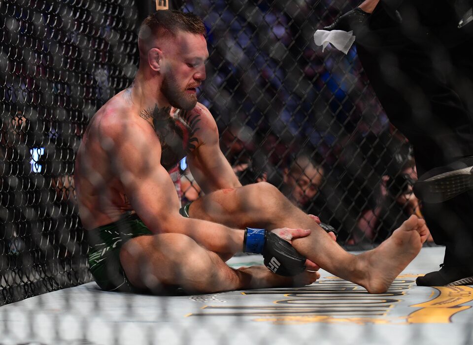 +Conor+Mcgregor+sitting+as+he+broke+his+leg+against+Dustin+Poirier+in+a+match