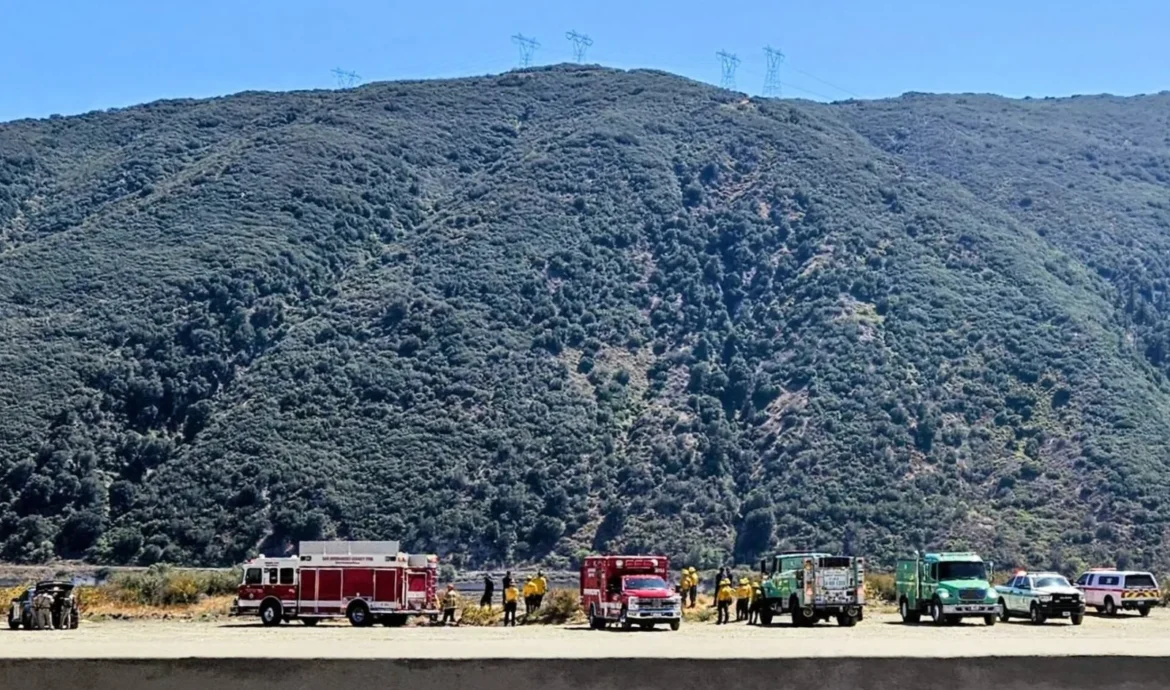Emergency crews respond to a crash scene off Interstate 15 in Cajon Pass
