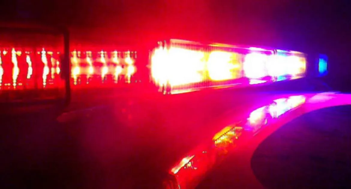 Police tape and emergency response vehicles near a closed Gilbert intersection after a deadly crash